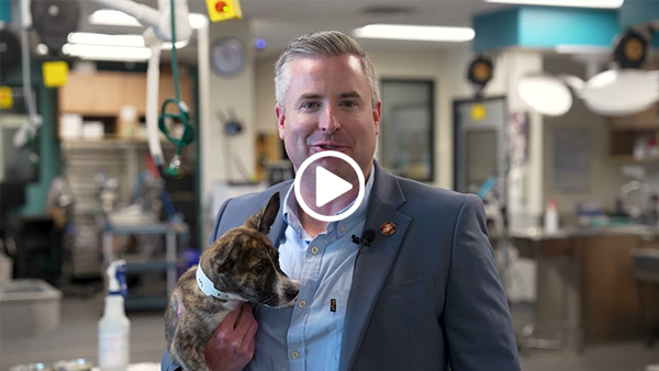 James McCain holding dog at a veterinary area