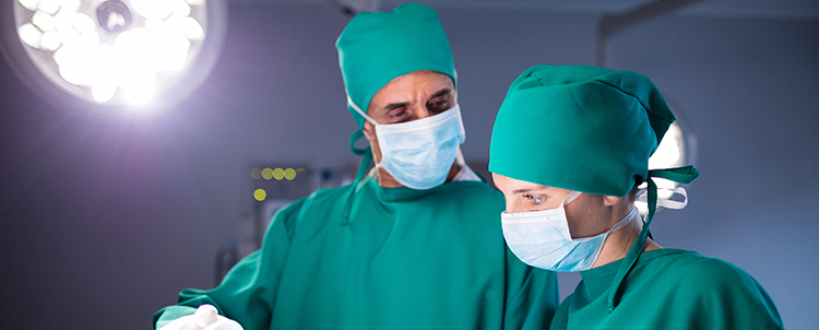 Female and male surgeons on full garb 