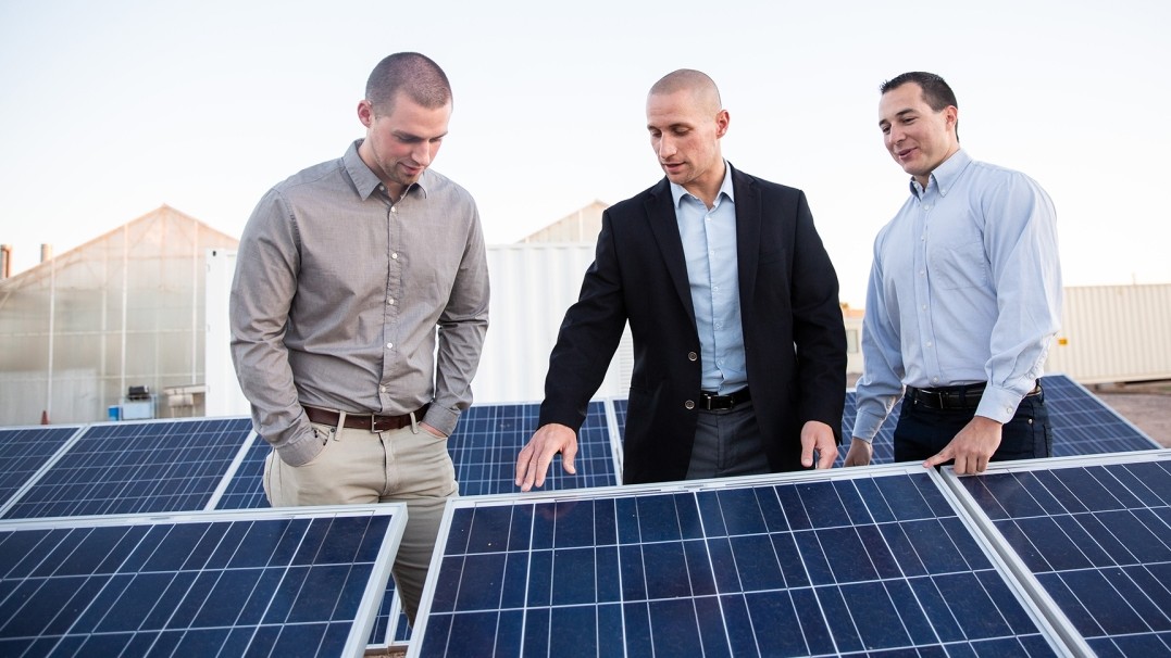 Nathan Johnson (center) inspects solar panels with colleagues. Johnson, a professor of engineering in The Polytechnic School, part of the Ira A. Fulton Schools of Engineering at Arizona State University, is the founder of the Laboratory for Energy And Power Solutions, or LEAPS, a consortium of researchers, students and industry stakeholders creating practical, scalable energy solutions.