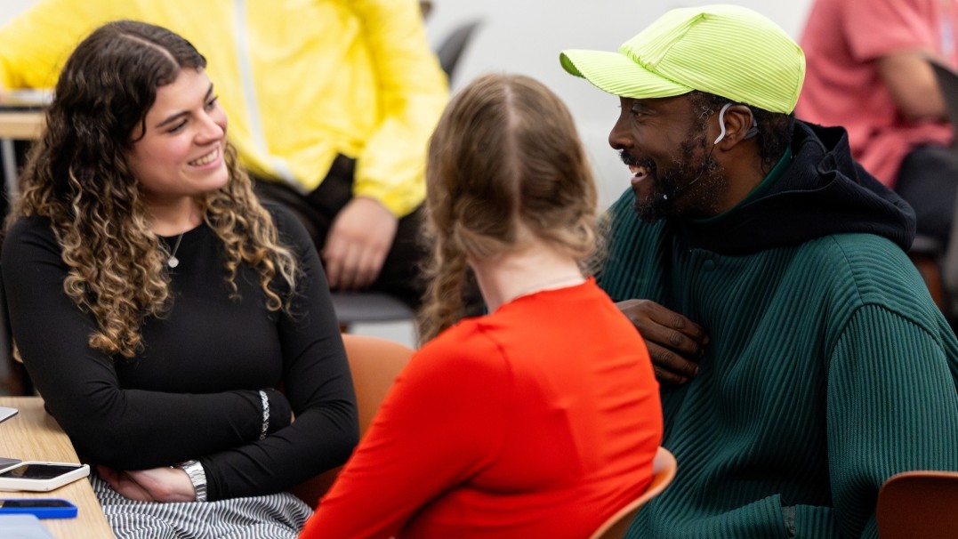 ASU Professor of Practice will.i.am chats with business students Noa Cohen (left) and Shayna Ilyinsky during a break in the “Agentic Self” course at Wilson Hall in Tempe. 