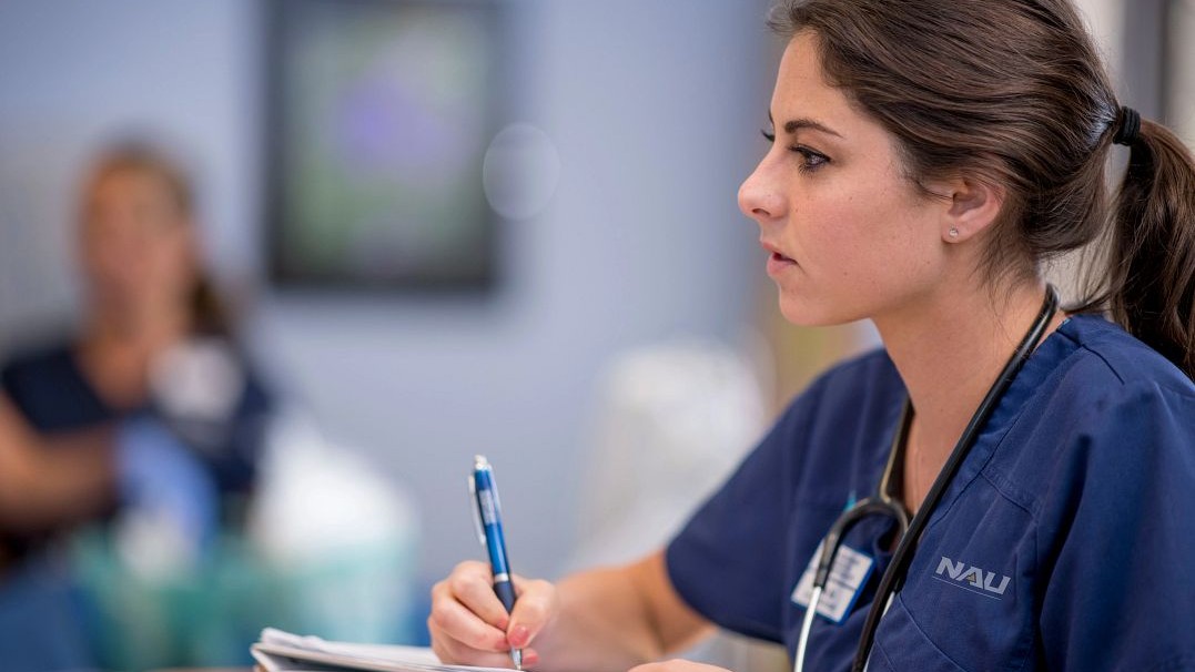 Image of a nursing student taking notes 