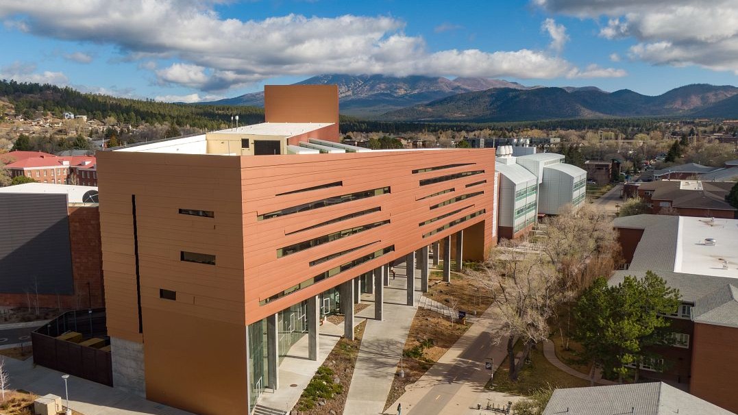 Exterior of the NAU Science and Health Building with the San Francisco Peaks in the background 