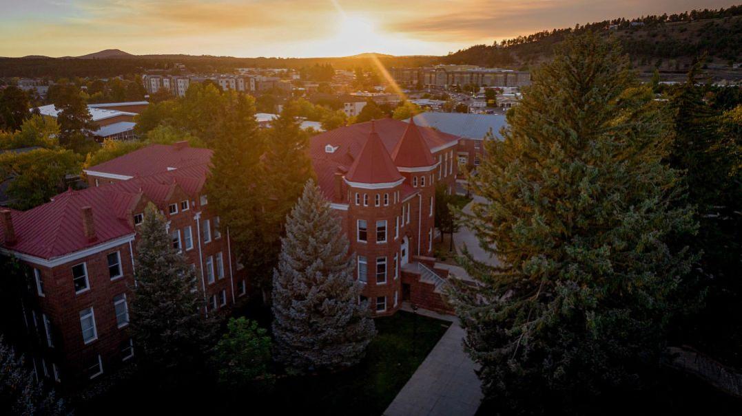 Aerial photo of NAU campus Old Main at sunset 