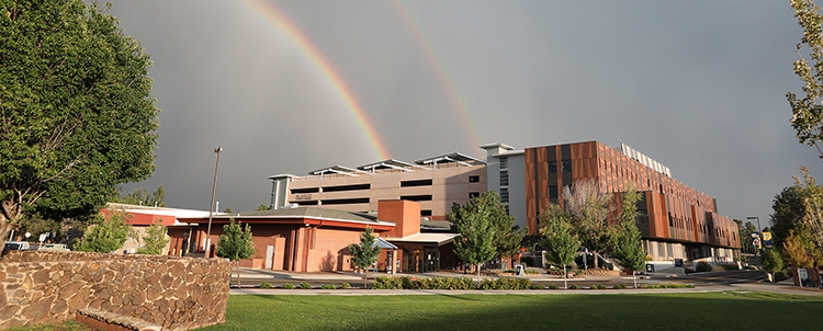 Image of a building on NAU's campus with a rainbow in the sky