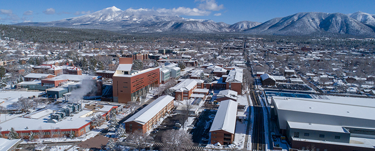 Overview image of NAU campus with snow and San Francisco Peaks in the background 