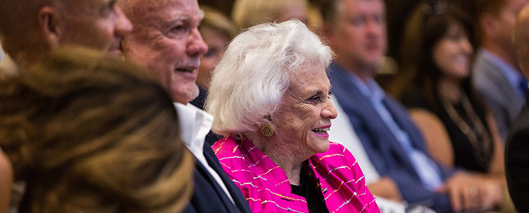 Photo of former Supreme Court Justice Sandra Day O'Connor smiling at an event 