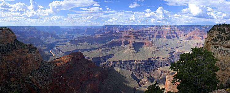 Overview photo of the Grand Canyon with clouds in the sky 